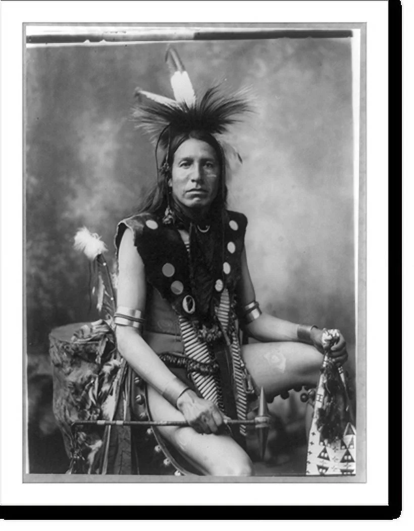 Historic Framed Print, [Yellow Shirt, three-quarter length portrait, seated, facing front; in feather headdress, holding tomahawk], 17-7/8