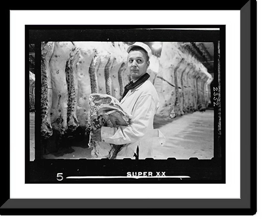 Historic Framed Print, [Butcher holding slab of beef in a meat locker], 17-7/8