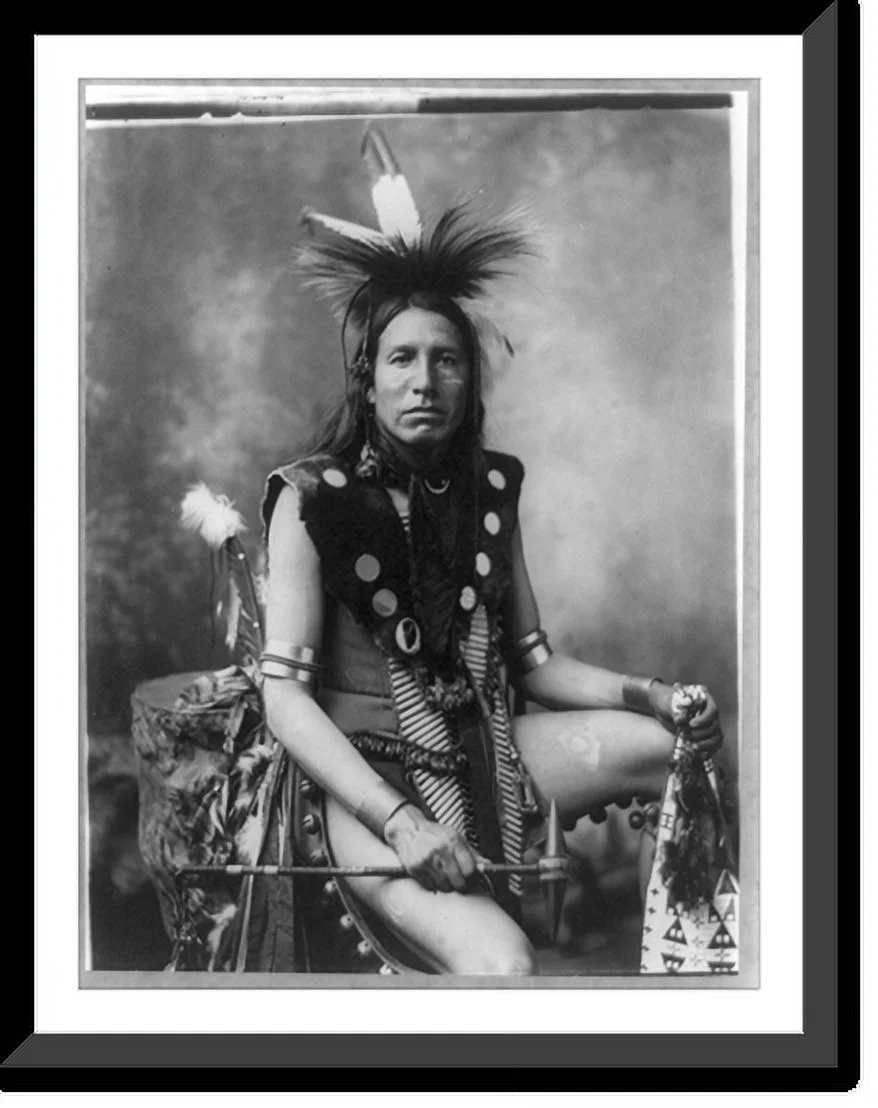 Historic Framed Print, [Yellow Shirt, three-quarter length portrait, seated, facing front; in feather headdress, holding tomahawk], 17-7/8