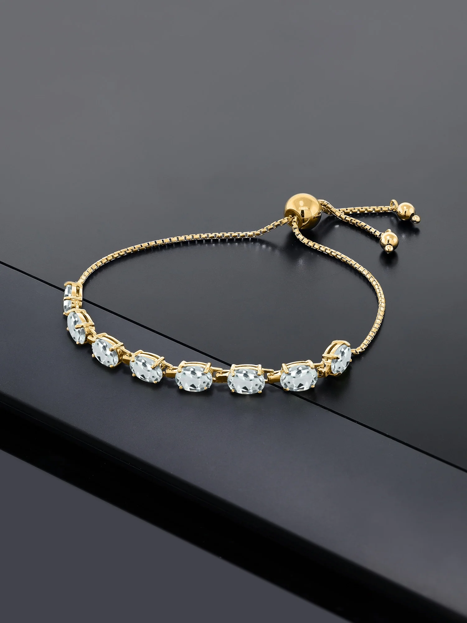 Gem Stone King 18K Yellow Gold Plated Silver Sky Blue Aquamarine Tennis Bracelet For Women (6.00 Cttw, Gemstone March Birthstone, Oval 7X5MM, Fully Adjustable Up to 9 inch)